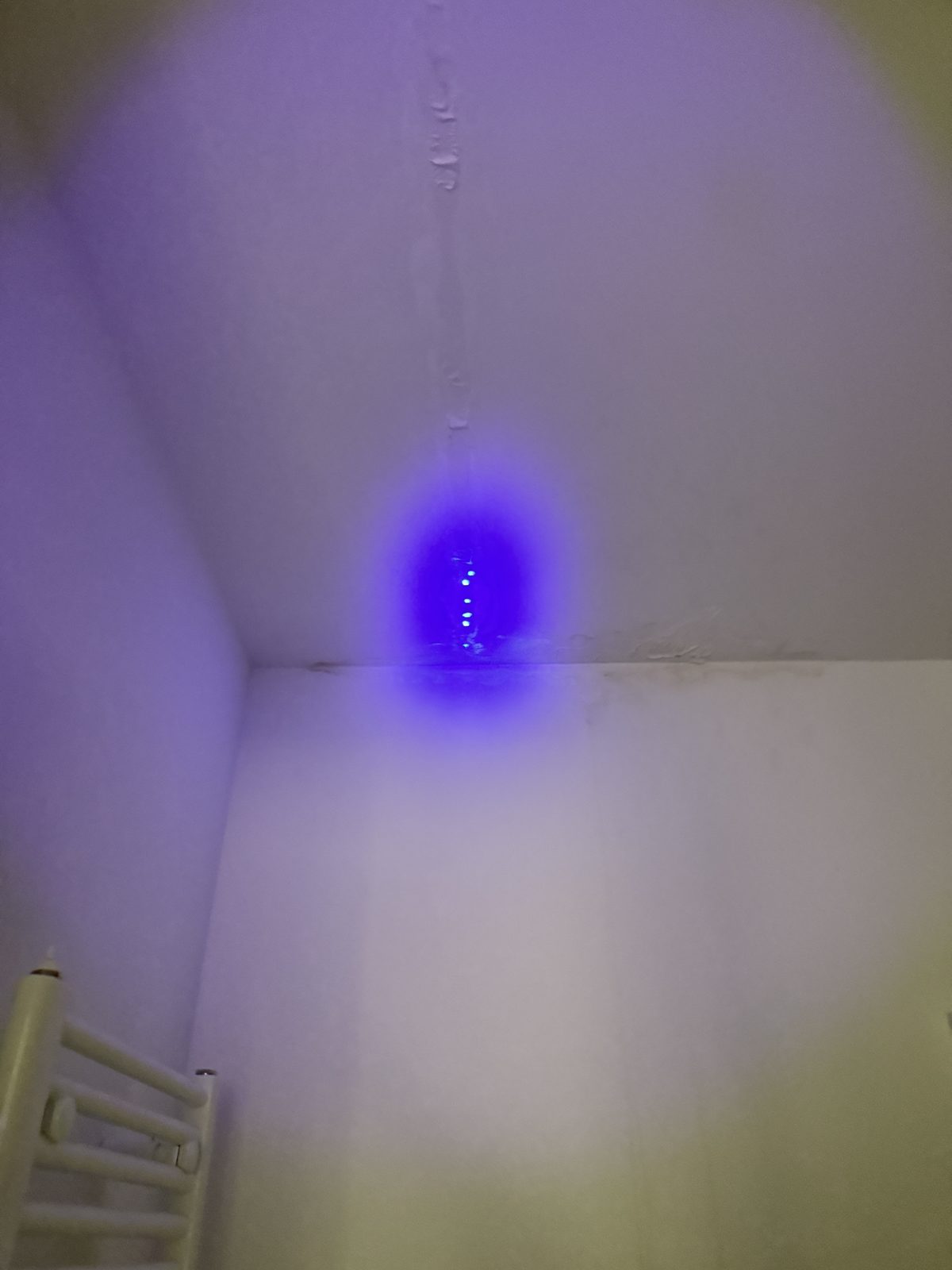 Traceur fluorescent révélé à la lampe UV dans la salle d'eau, preuve du passage de l'eau, à Toulouse